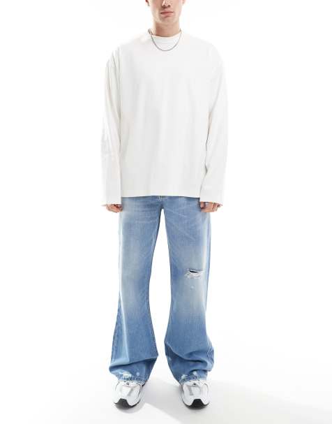 ASOS DESIGN – Jasnoniebieskie jeansy z rozszerzanymi nogawkami, przebarwieniami i rozdarciami - view 1