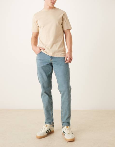 ASOS DESIGN – Jasnoniebieskie jeansy ze zwężanymi nogawkami, stretchem, efektem sprania i przebarwieniami - view 1