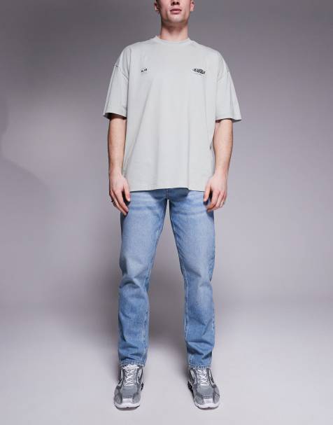 ASOS DESIGN tapered fit jeans in light wash blue