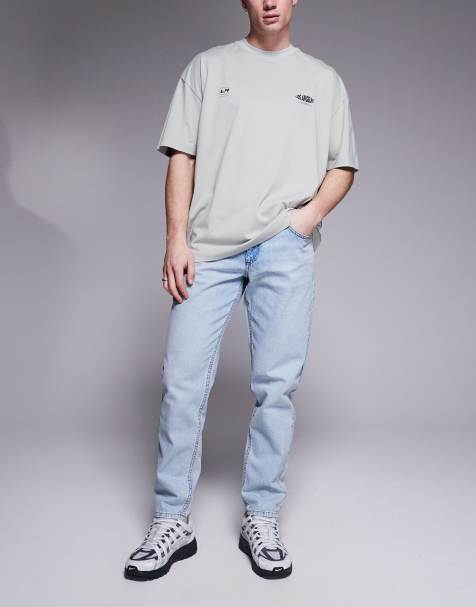 ASOS DESIGN tapered fit jeans in light wash blue