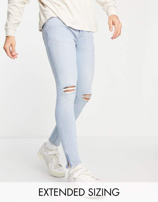 ASOS DESIGN – Jasnoniebieskie przylegające elastyczne jeansy z rozdarciami na kolanach i zamkami na dole