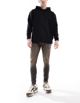 ASOS DESIGN - Jean effet vaporisé en tissu power stretch - Noir délavé teinté