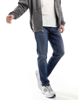 ASOS DESIGN stretch tapered jeans in mid wash blue - ASOS Price Checker