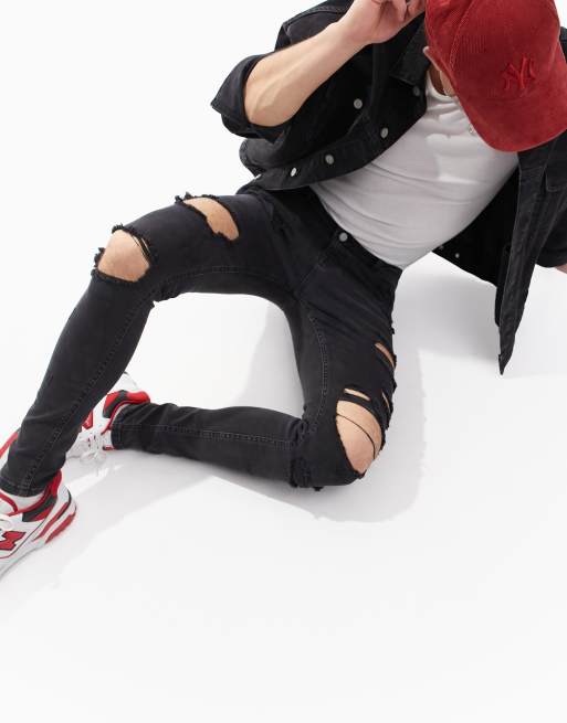 ASOS DESIGN - Jean seconde peau en power stretch avec déchirures sur la cuisse - Noir délavé