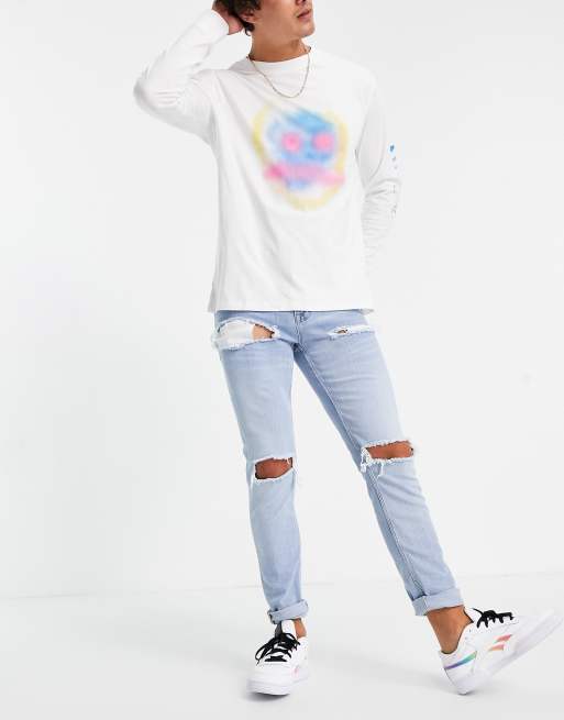 ASOS DESIGN - Jean skinny avec larges déchirures - Délavage clair