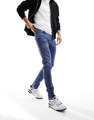 ASOS DESIGN skinny jeans in mid wash blue - ASOS Price Checker