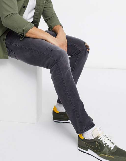 ASOS DESIGN - Jean slim stretch effet usé avec déchirures aux genoux - Noir délavé