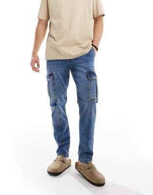 ASOS DESIGN stretch tapered jeans with cargo pockets in mid wash blue - ASOS Price Checker