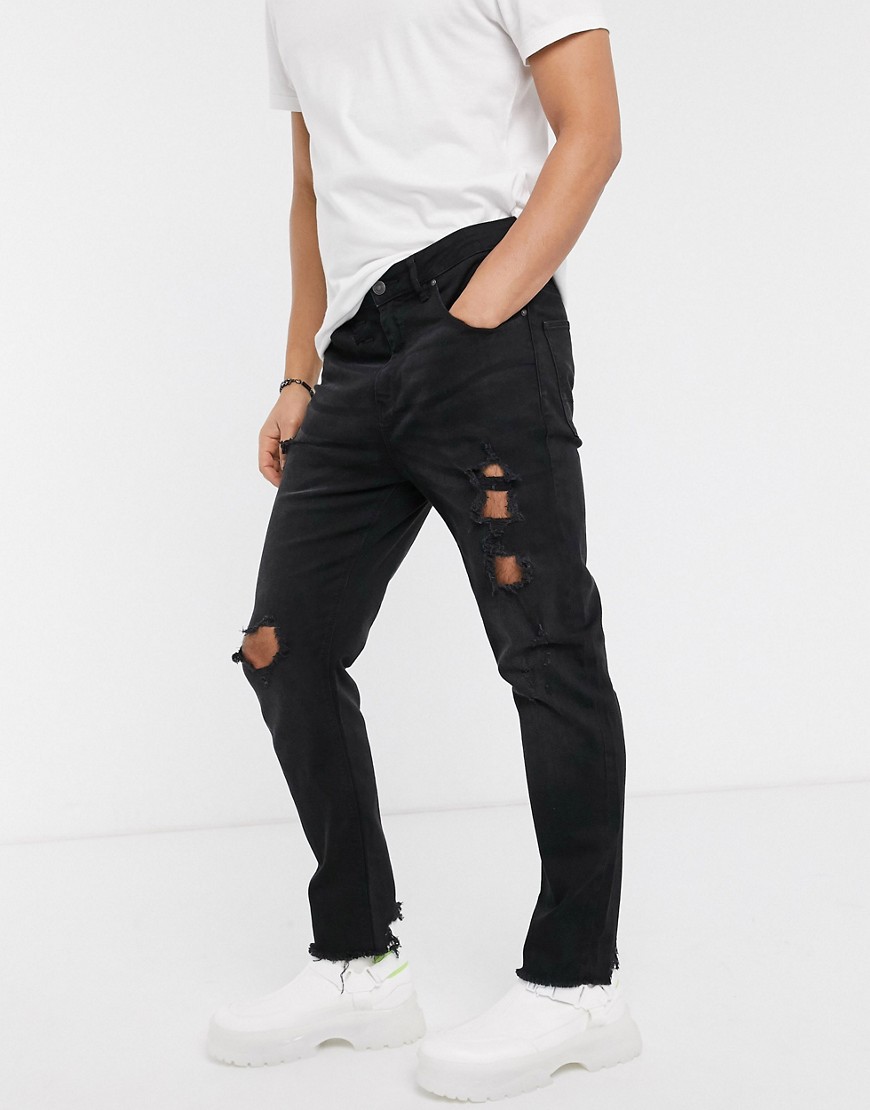 ASOS DESIGN - Jeans affusolati nero slavato con strappi vistosi