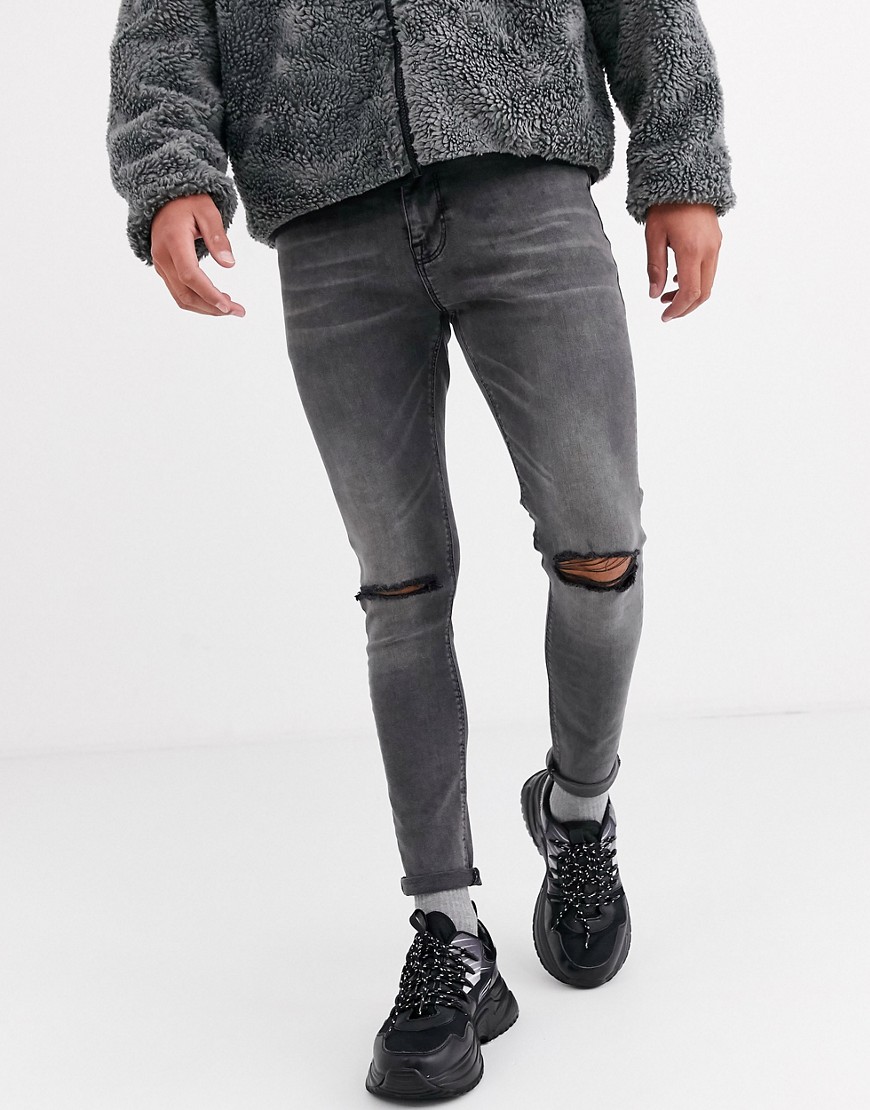 ASOS DESIGN - Jeans effetto spray in denim power stretch nero slavato con strappi alle ginocchia