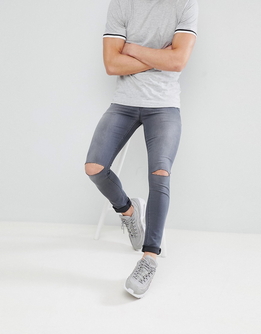 ASOS DESIGN - Jeans grigio délavé spray on con strappi alle ginocchia