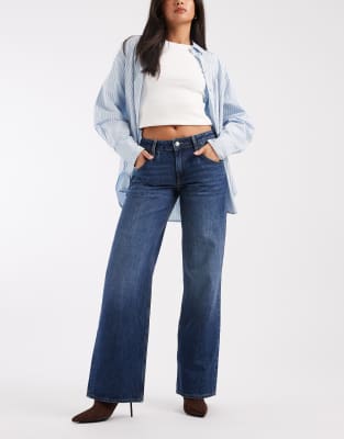ASOS DESIGN - Jeans in dunklem Mittelblau mit niedrigem Bund und weitem Schnitt