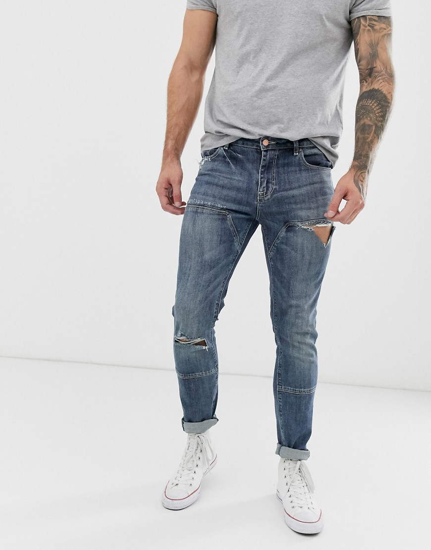 ASOS DESIGN - Jeans skinny blu lavaggio scuro con strappi e pannelli cut and sew