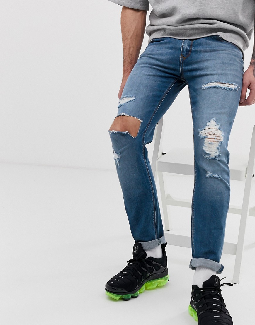 ASOS DESIGN - Jeans skinny blu medio slavato con strappi vistosi
