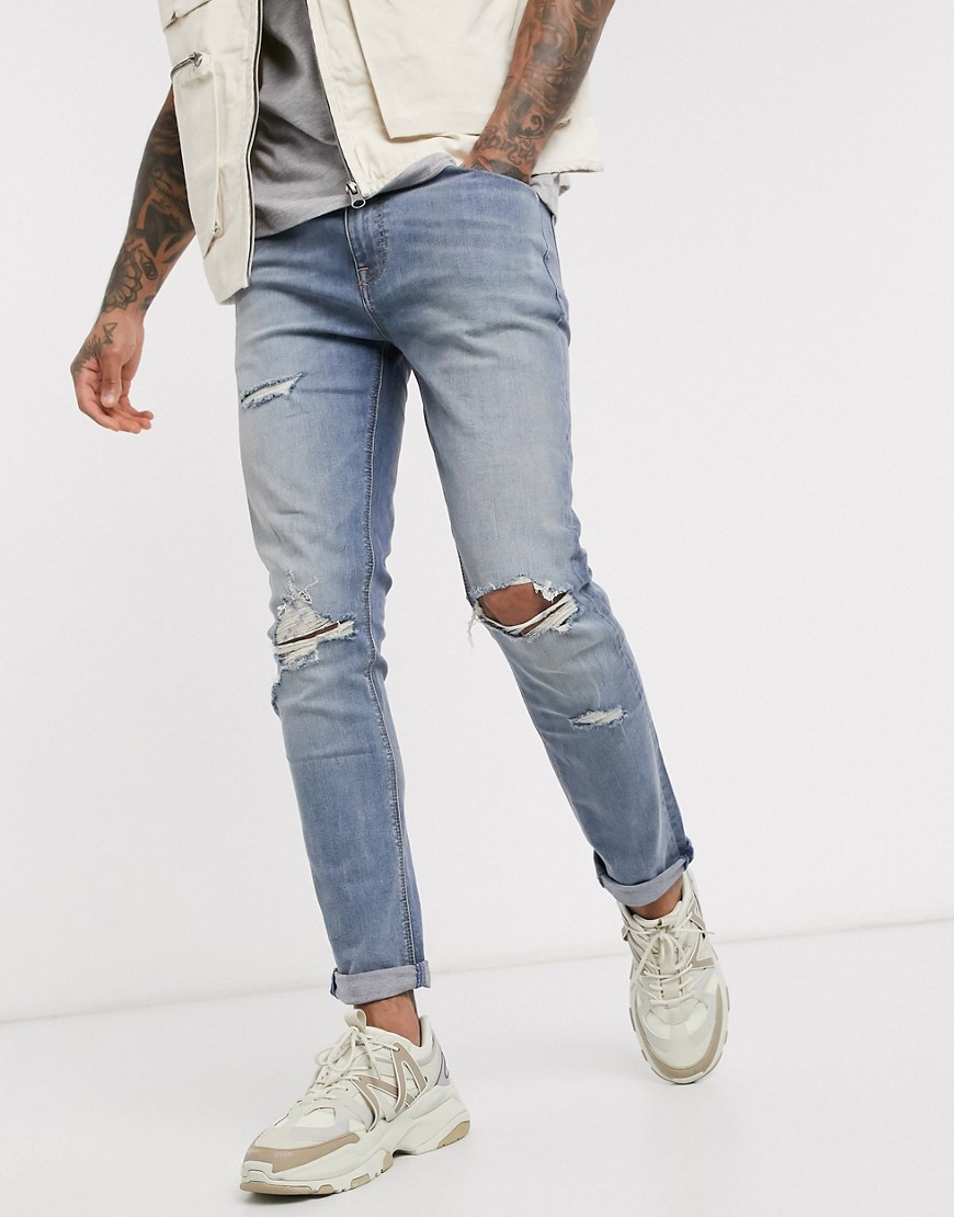 ASOS DESIGN - Jeans skinny lavaggio blu medio vintage con ginocchia strappate