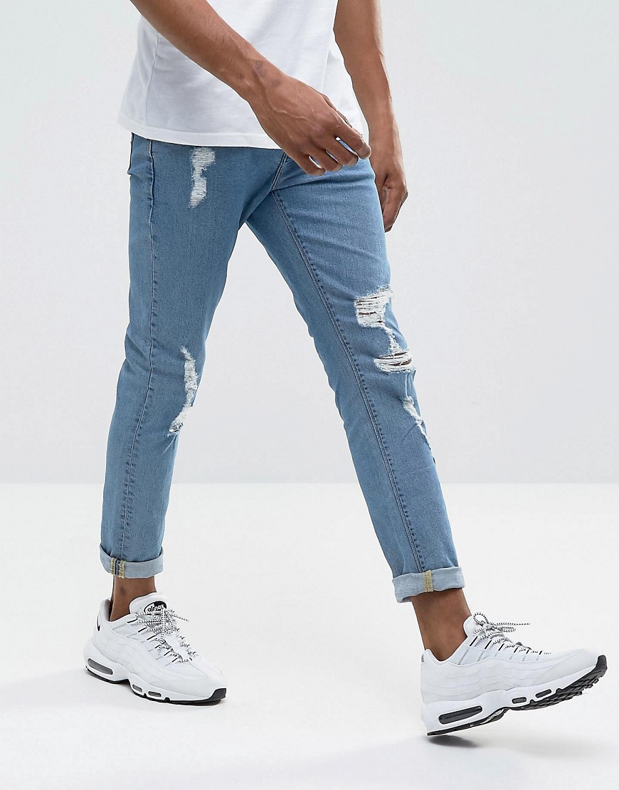 ASOS DESIGN - Jeans skinny lavaggio medio con strappi evidenti-Blu