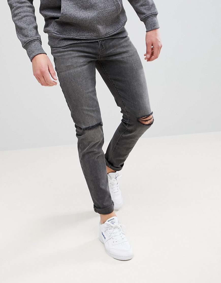 ASOS DESIGN - Jeans skinny nero slavato vintage con strappi alle ginocchia