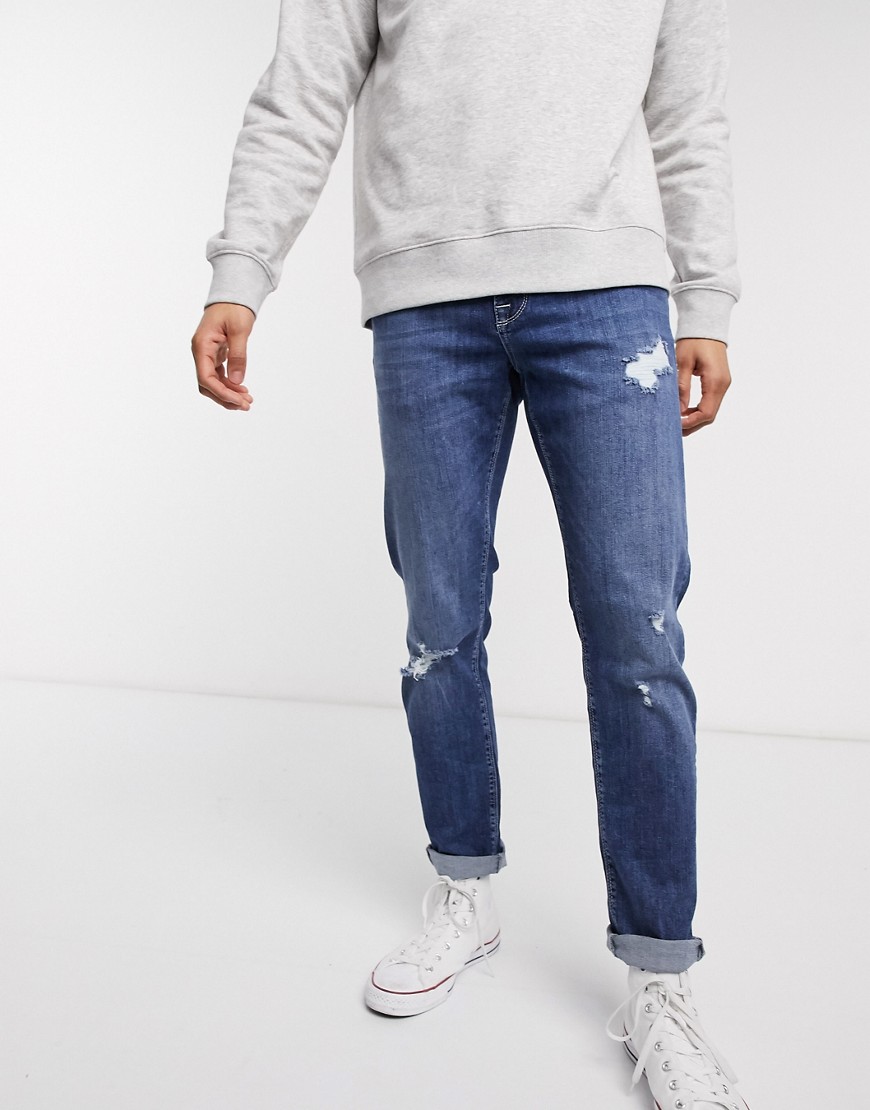 ASOS DESIGN - Jeans slim elasticizzati lavaggio blu scuro con abrasioni