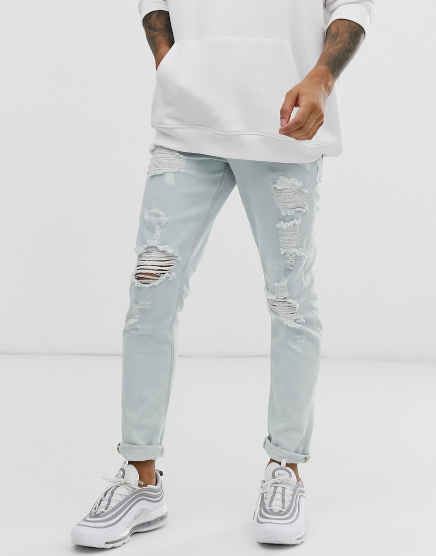 ASOS DESIGN - Jeans slim lavaggio chiaro blu con strappi pesanti