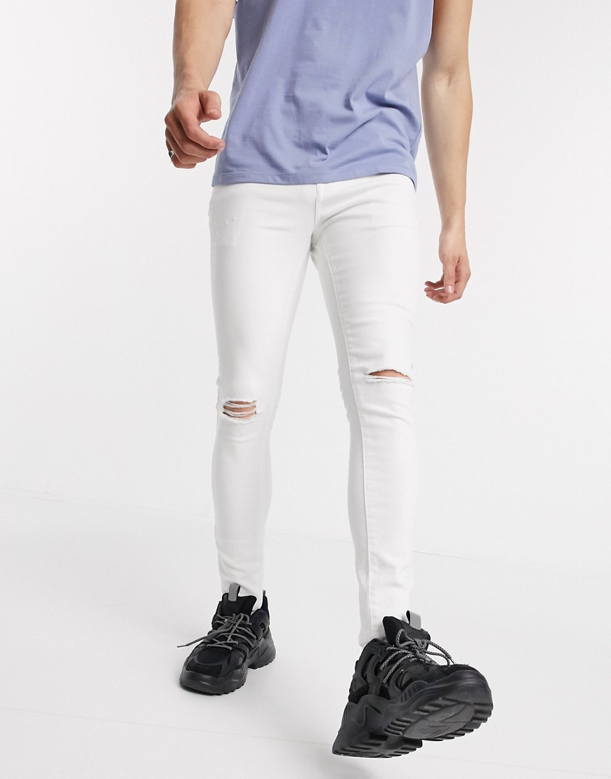 ASOS DESIGN - Jeans spray on power stretch bianchi con strappi alle ginocchia-Bianco