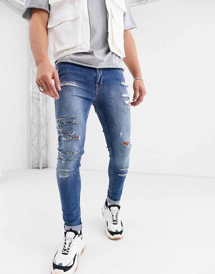 ASOS DESIGN - Jeans super skinny blu lavaggio chiaro con strappi vistosi