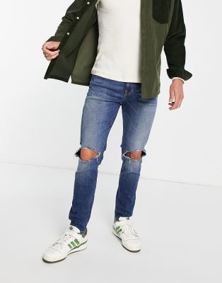 ASOS DESIGN – Jeansy o obcisłym kroju z ciemnoniebieskiego denimu z rozdarciami na kolanach