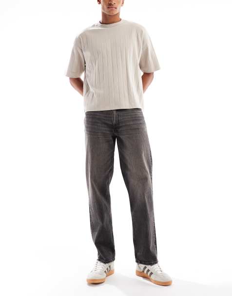 ASOS DESIGN – Jeansy o prostym kroju w spranym czarnym kolorze z żółtymi przebarwieniami - view 1