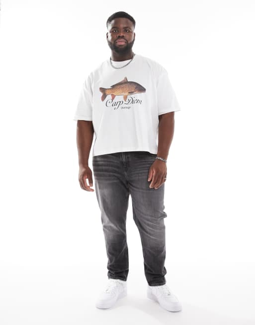 ASOS DESIGN – Jeansy ze zwężanymi nogawkami i stretchem w spranym czarnym kolorze z przebarwieniami w stylu vintage