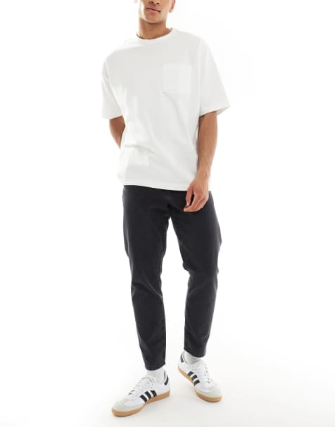 ASOS DESIGN – Jeansy ze zwężanymi nogawkami w czarnym kolorze z efektem sprania - view 1