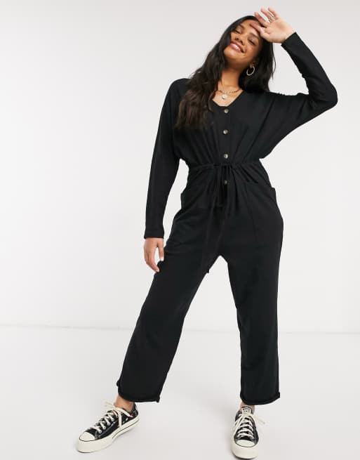 ASOS DESIGN - Jersey jumpsuit met knoopsluiting voor, lange mouwen en gestrikte taille in zwart