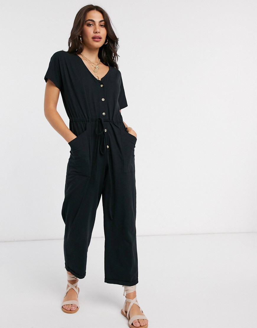 ASOS DESIGN - Jersey jumpsuit met knopen aan de voorkant en strikceintuur in zwart