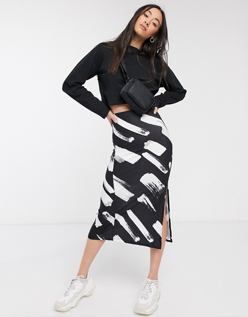 ASOS DESIGN jersey midi skirt with split in mono splodge print
