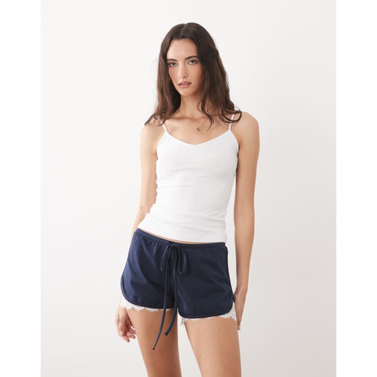 ASOS DESIGN jersey shorts with lace under layer in navy | ASOS