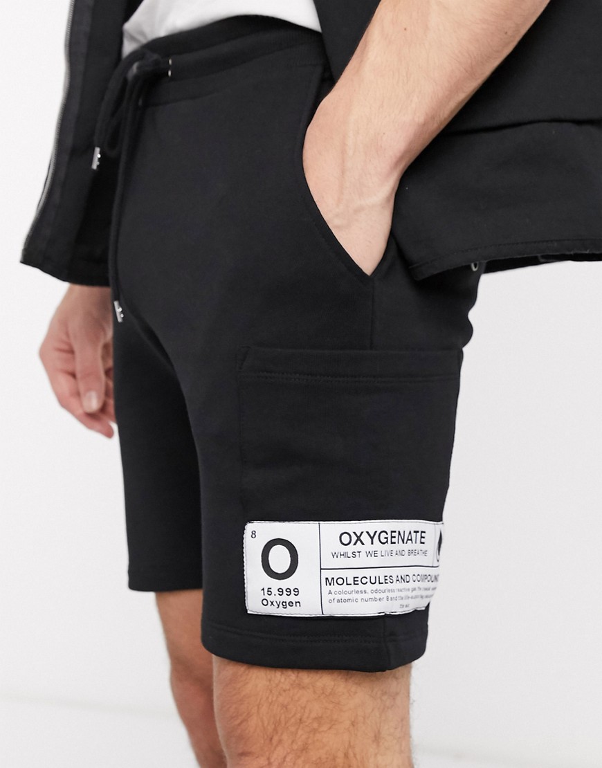ASOS DESIGN - Jersey skinny short met zijzakken en patch in zwart