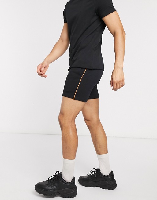 ASOS DESIGN jersey skinny shorts in black with neon piping
