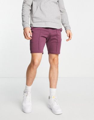ASOS DESIGN jersey skinny shorts with pin tucks in burgundy