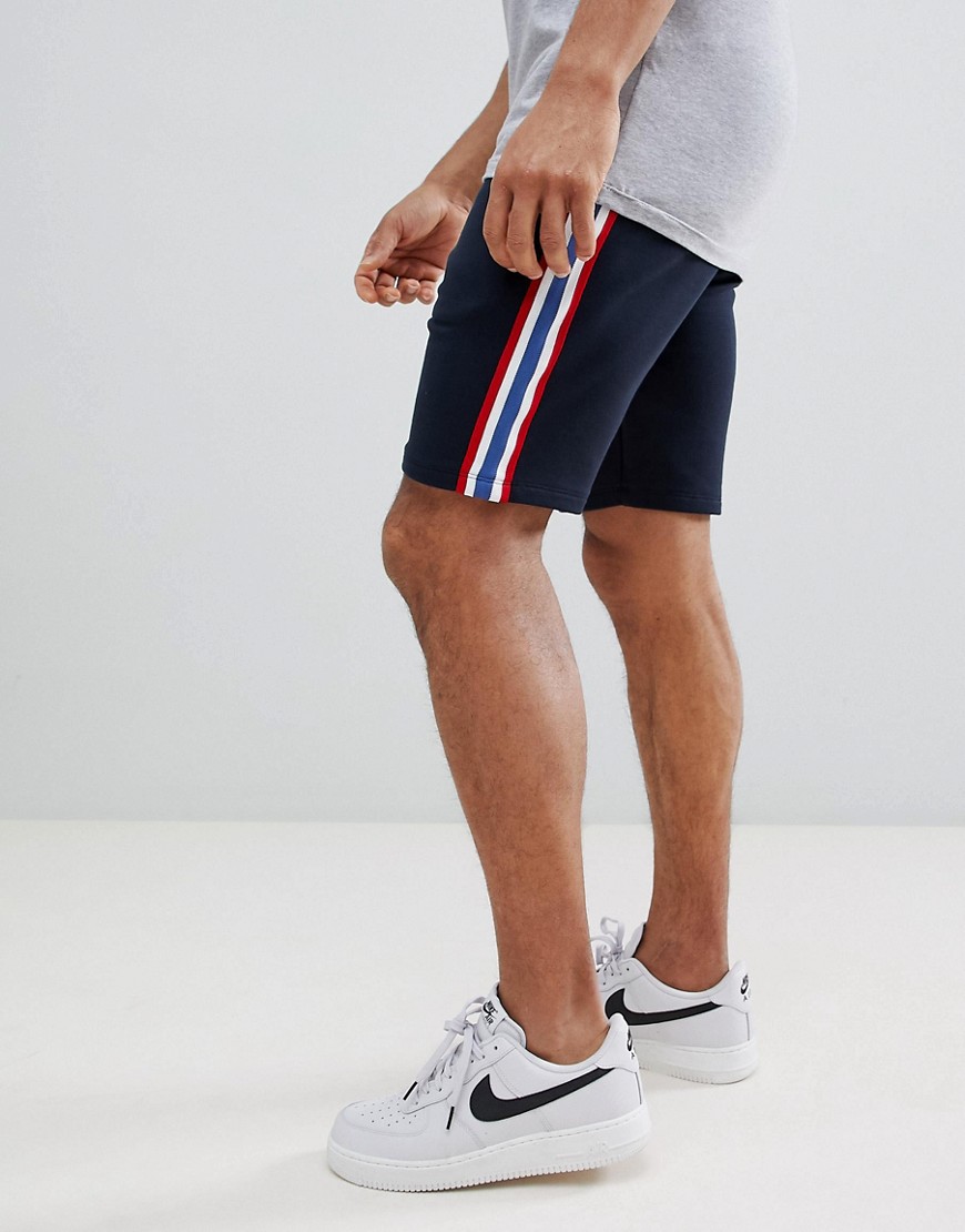 ASOS DESIGN jersey skinny shorts with side stripe in navy