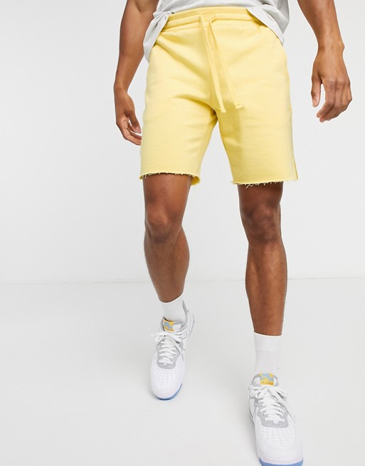 ASOS DESIGN jersey slim shorts with raw hem and flat drawcords in yellow