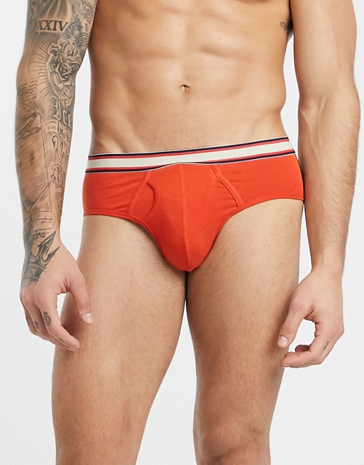 ASOS DESIGN jock strap in orange organic cotton with red and yellow stripe waistband