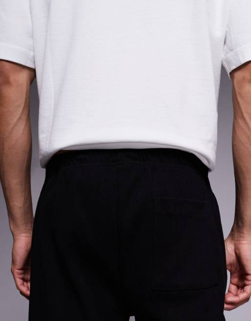 ASOS DESIGN - Joggers affusolati in tessuto pesante neri con orlo fisso e pinces, 4 di 5