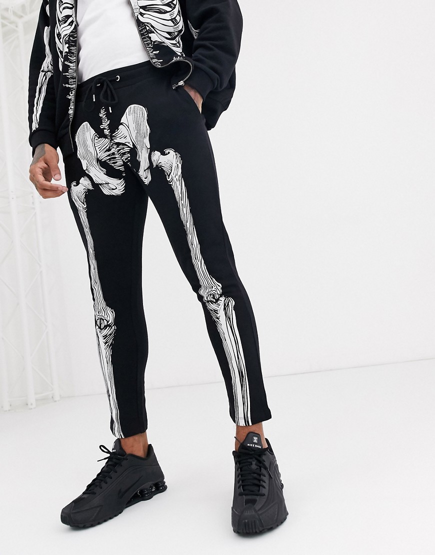 ASOS DESIGN - Joggers skinny neri con stampa con scheletro per Halloween in coordinato-Nero
