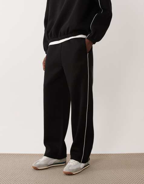 ASOS DESIGN – Jogginghose in Schwarz mit weitem Schnitt und Paspelierung - view 1