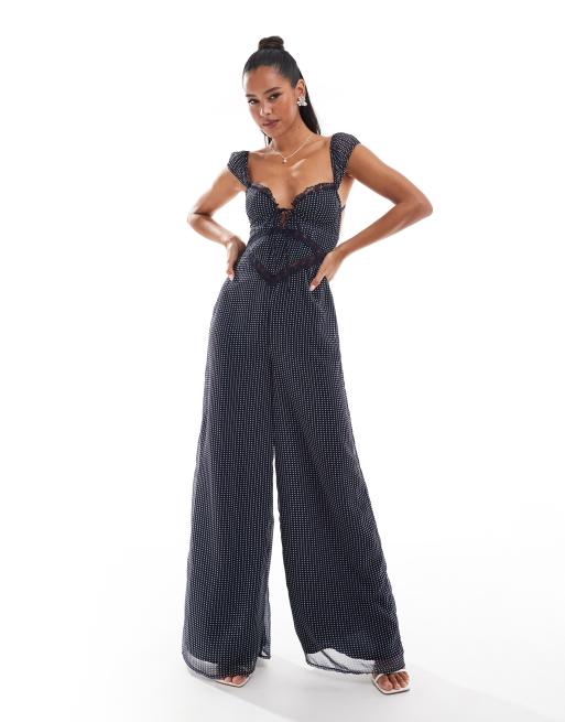 ASOS DESIGN - Jumpsuit met kanten inzetstuk, korsetdetail, wijde pijpen en stippen in zwart