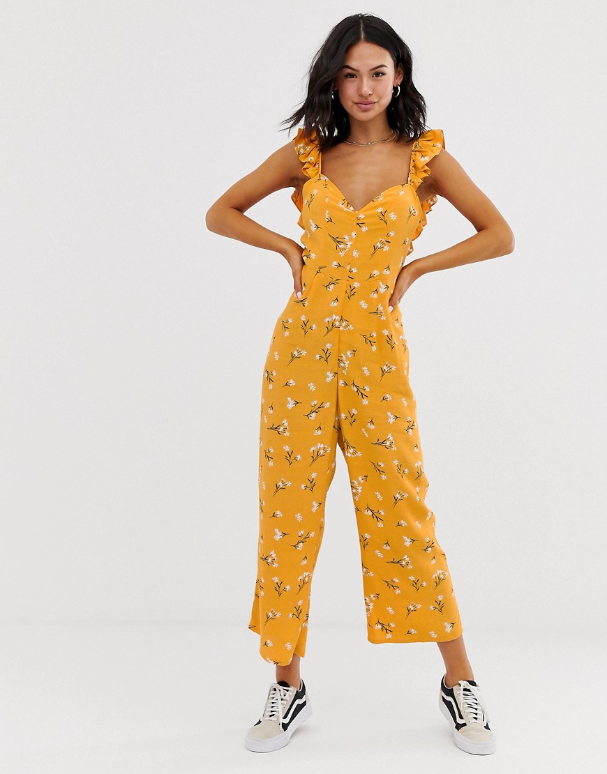 ASOS DESIGN - Jumpsuit met ruchebandjes, gestrikte achterkant en bloemenprint in geel