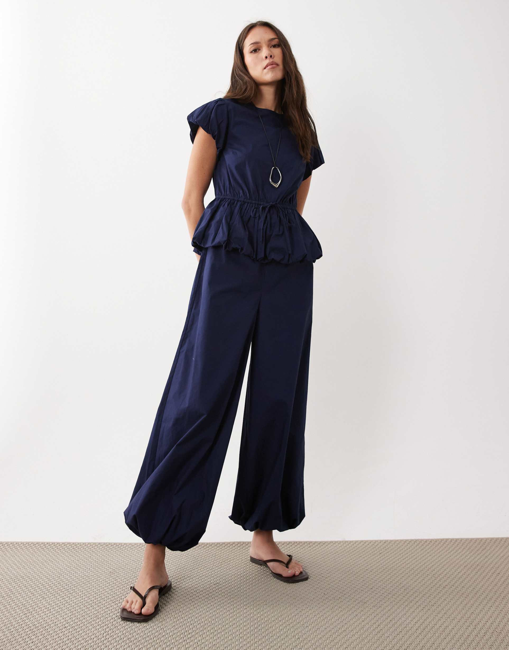 asos design jumpsuit with peplum and balloon legs in navy