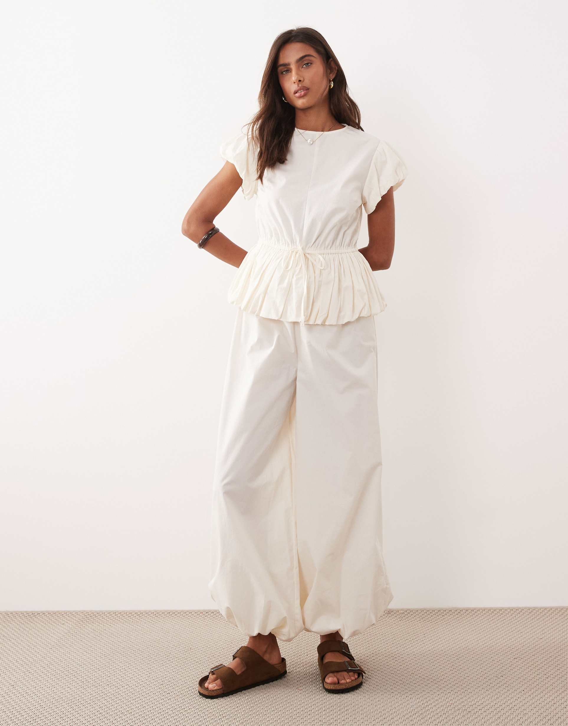 asos design jumpsuit with peplum waist and balloon legs in cream