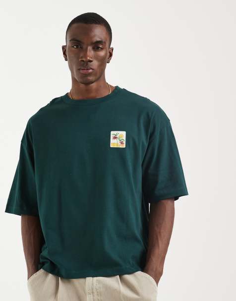 ASOS DESIGN – Kastig geschnittenes Oversize-T-Shirt in Dunkelgrün mit Blumen-Print auf der Brust - view 1