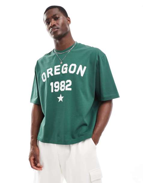 ASOS DESIGN – Kastiges Oversize-T-Shirt in Dunkelgrün mit „Oregon“-Print vorne und Zierstreifen an der Schulter - view 1