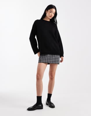ASOS DESIGN knit sweater dress with woven plaid hem in black