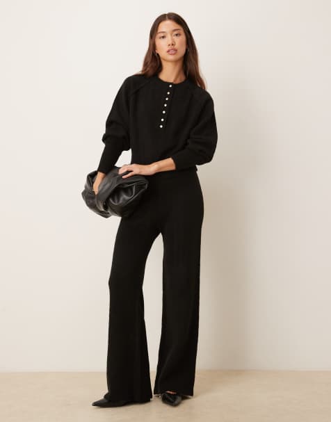 ASOS DESIGN knitted long sleeve henley jumper with gold buttons & wide leg trousers co-ord in black - view 1